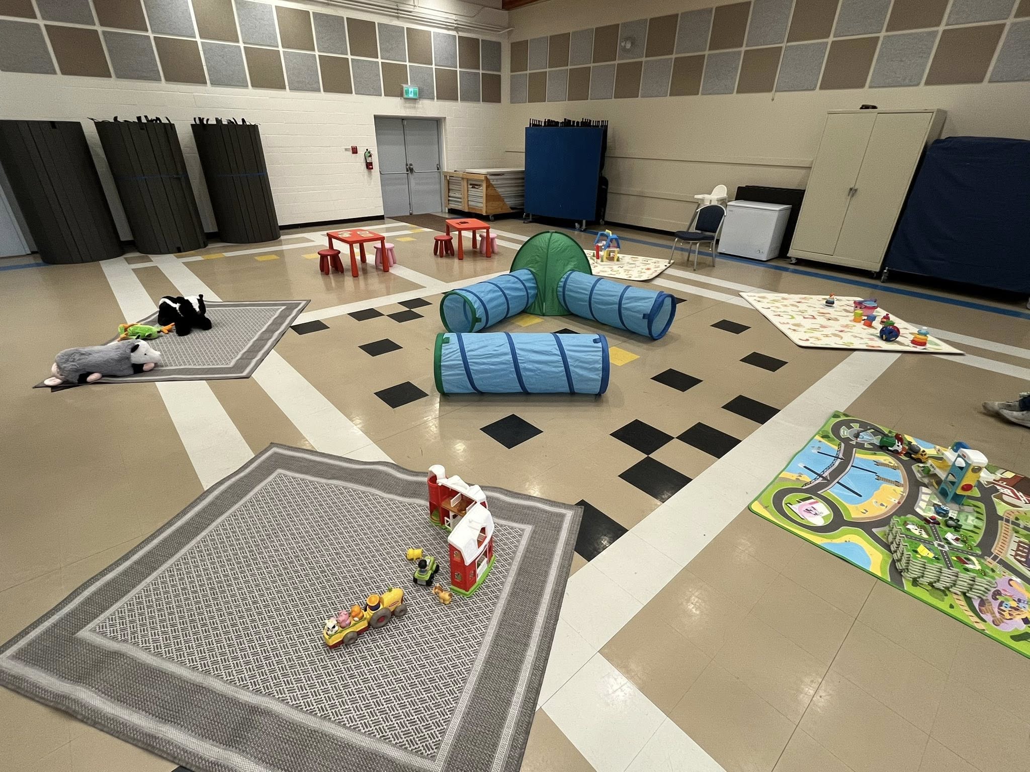 Church gym set up for a children’s playgroup with play mats, toys, and soft play equipment.