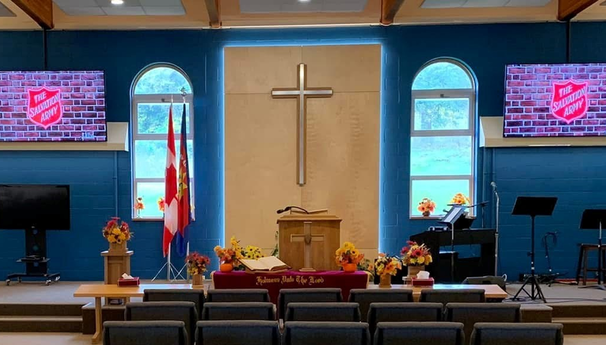 Interior of the Nanaimo Community Church sanctuary, featuring a cross at the front, seating for worship, and a welcoming worship space.