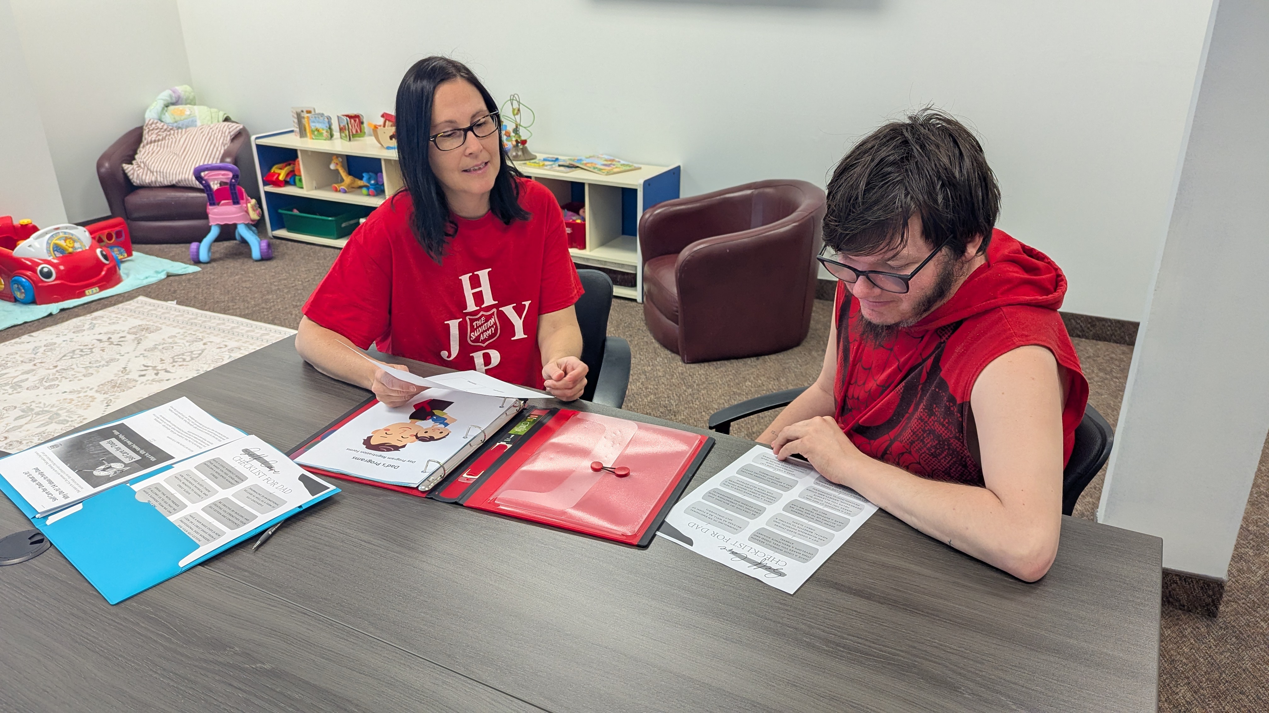Salvation Army staff walk client through parenting skills